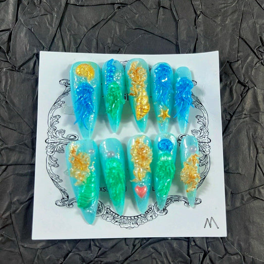 MellowBells press-on nails with blue embossed finish for a chic instant manicure.