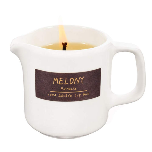 MELONY coconut-scented soy massage oil candle on a wooden surface
