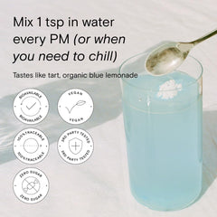 Moon Juice Magnesi-Om Blue Lemon stick in a glass ready to sip