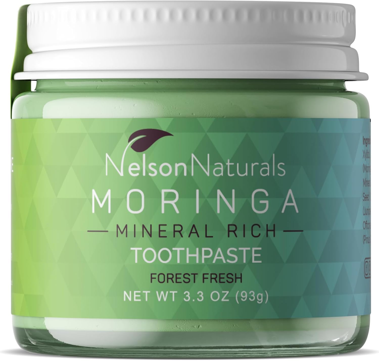 Moringa toothpaste in a clear glass jar with zero waste packaging