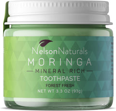 Moringa toothpaste in a clear glass jar with zero waste packaging