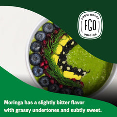 Moringa powder being added to a smoothie