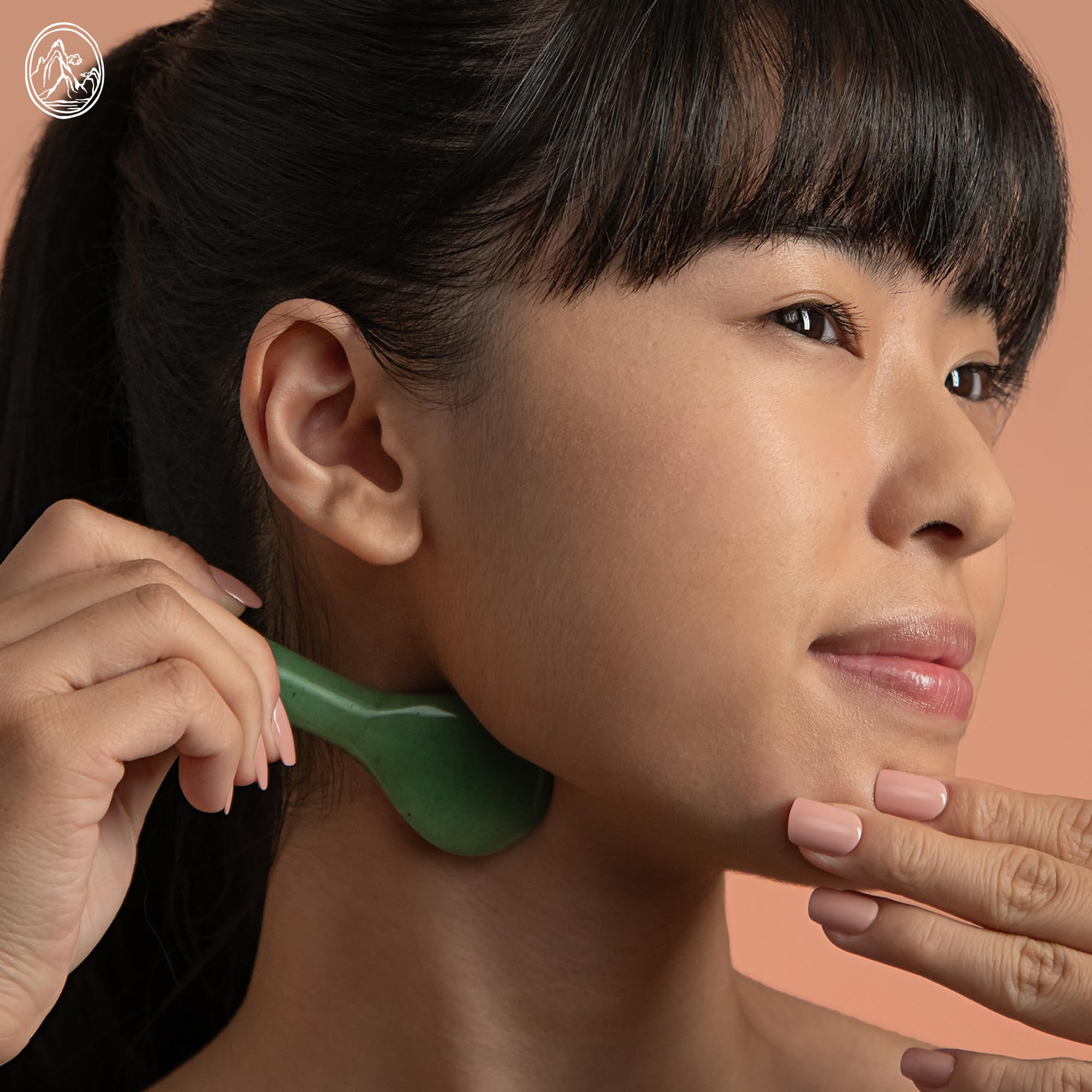 Gua sha tool in use on facial skin