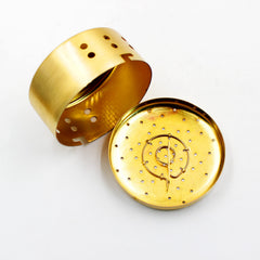 Top view of copper burner box showing air holes