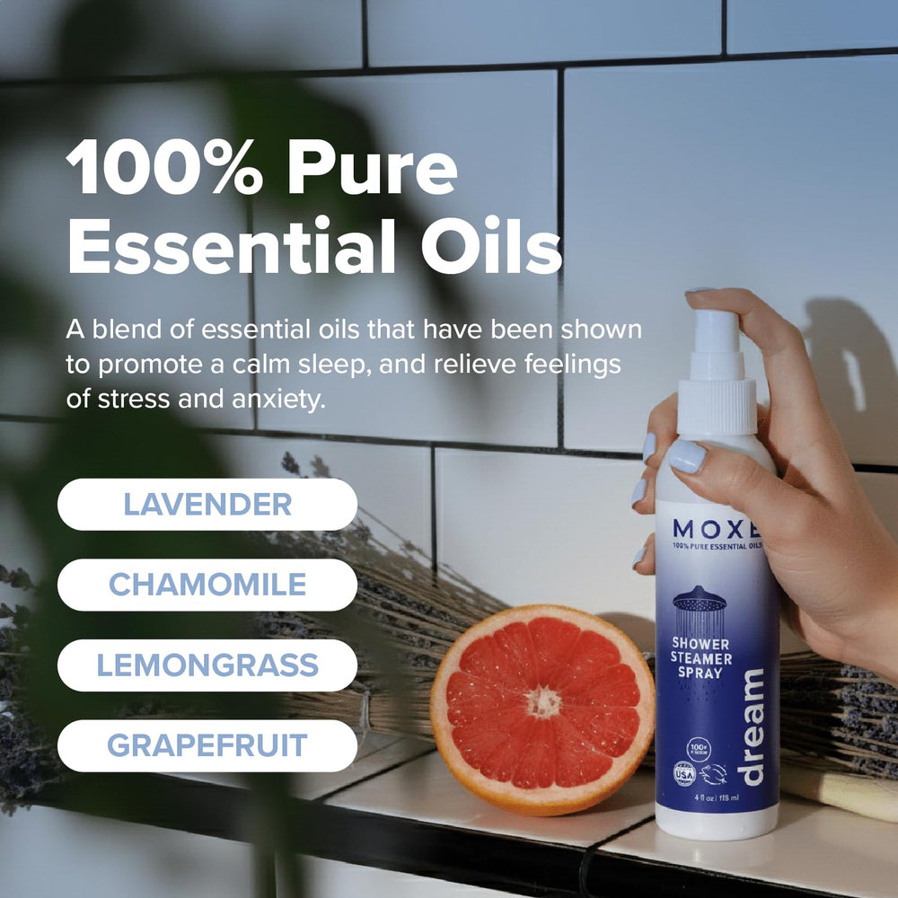 Hands spraying Dream mist into shower steam