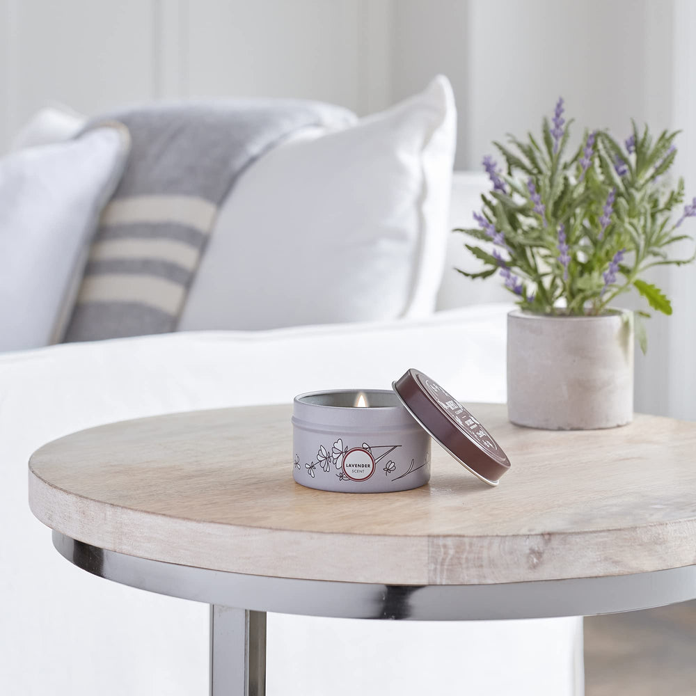 Lavender tin candle burning in a cozy home setting