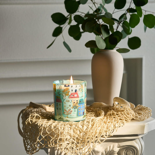 Close-up of 10.2 oz soy wax candle surface showcasing warm tones and CharmArch artwork