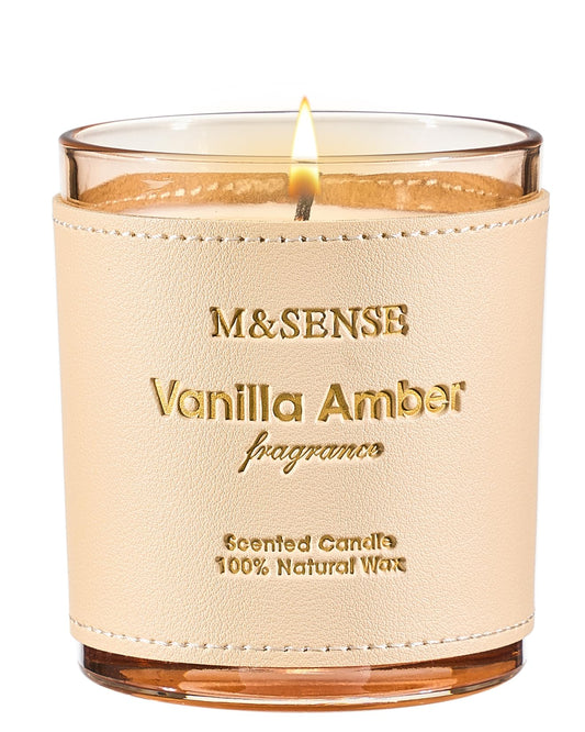 Close-up of M&SENSE Vanilla Amber scented candle with hand-stitched leather sleeve