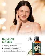 Neroli essential oil bottle beside fresh orange blossoms