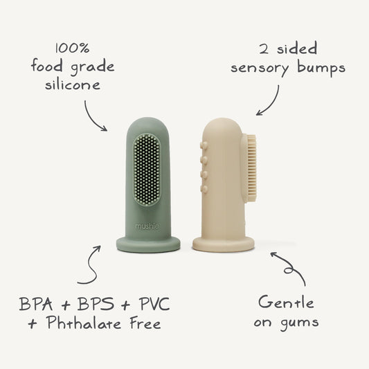 On-hand view: Mushie finger toothbrush – angle 1