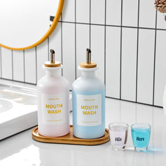Two 11.8oz glass mouthwash bottles with stainless steel spouts