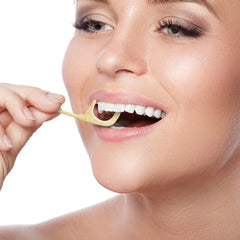 Floss picks in use cleaning between teeth