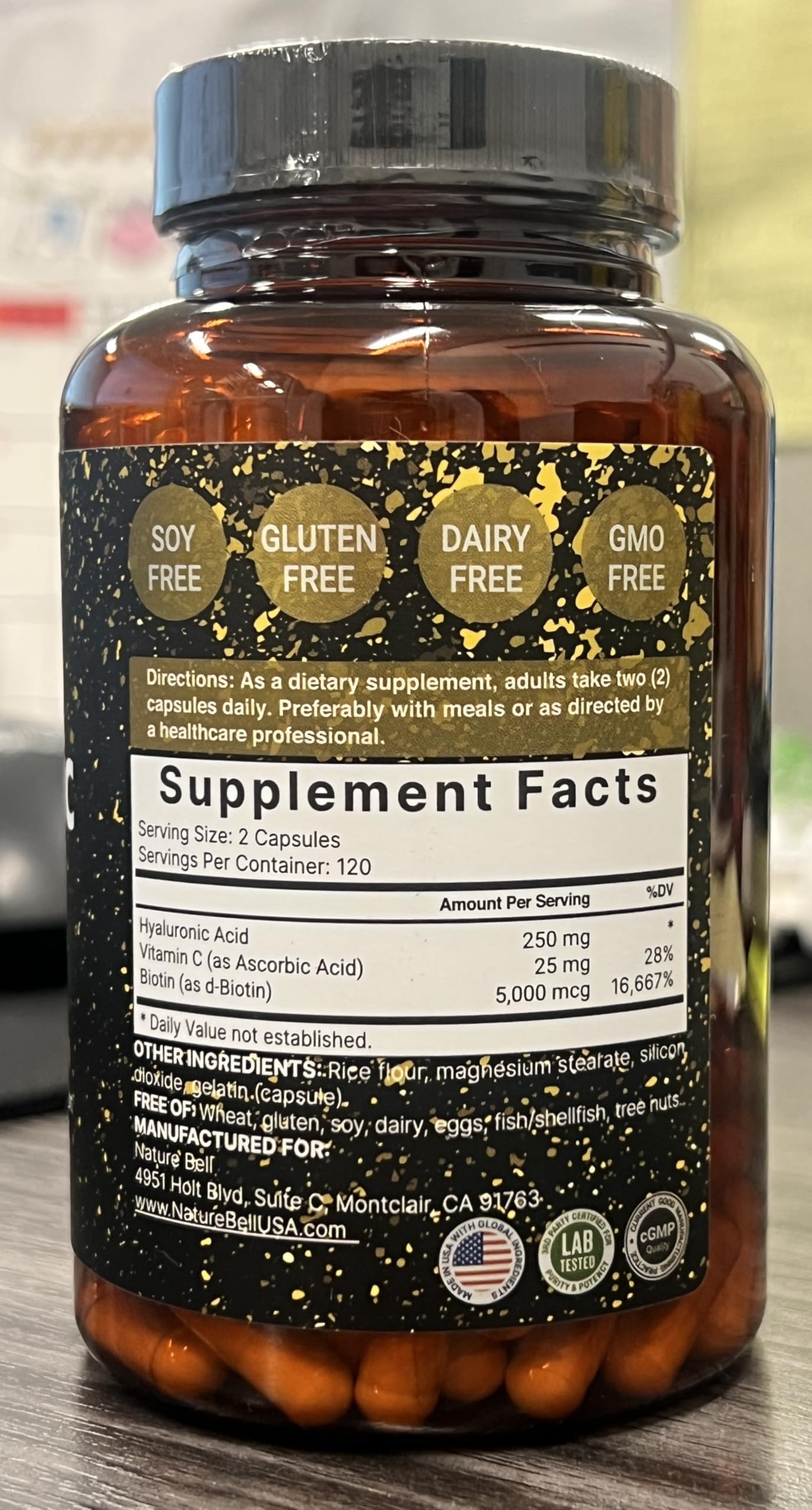 Close-up of NatureBell bottle label showing 3-in-1 formula with biotin and vitamin C
