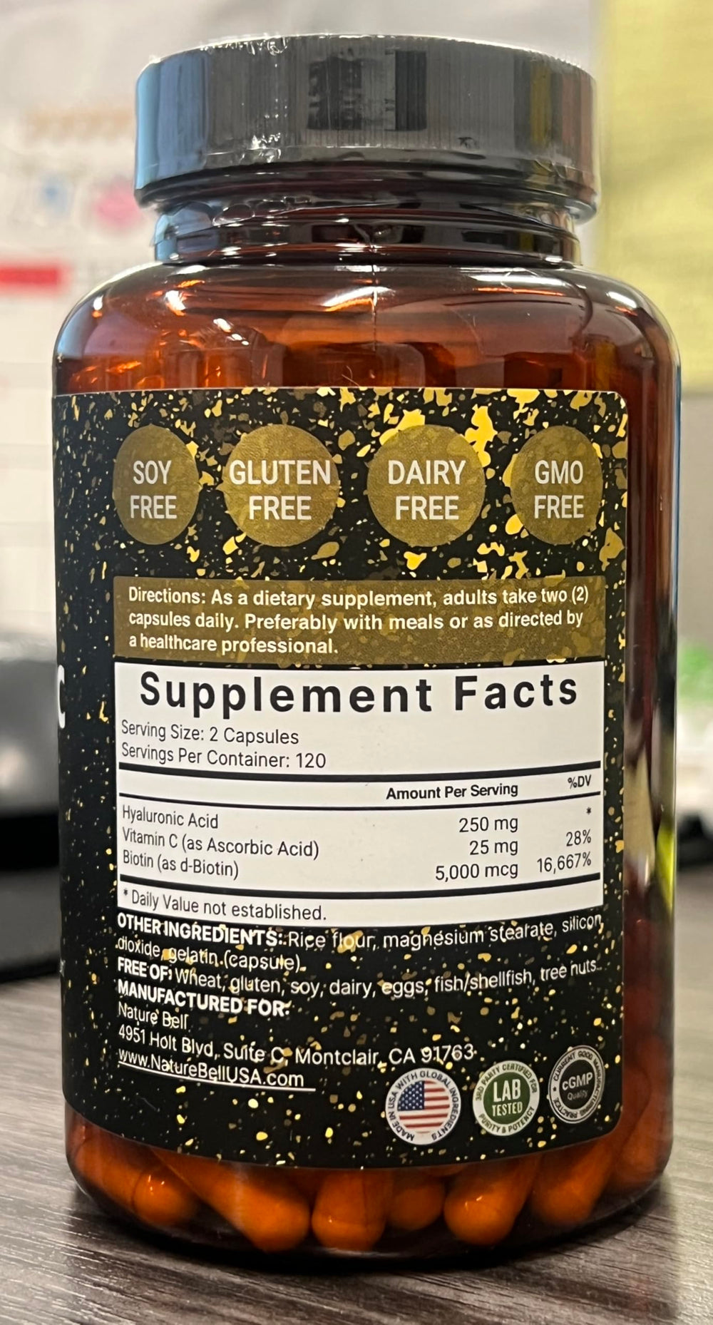 Close-up of NatureBell bottle label showing 3-in-1 formula with biotin and vitamin C