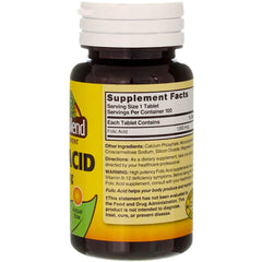 Close-up of a single folic acid tablet