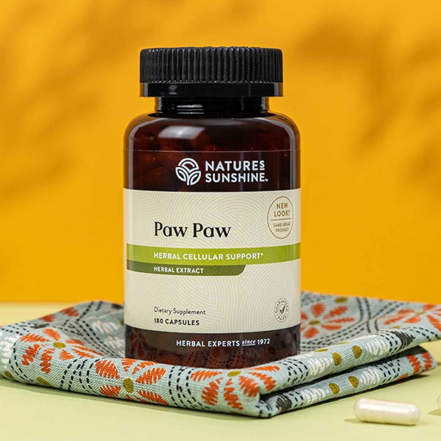 North American paw paw tree leaves illustrate sustainable sourcing behind the product.