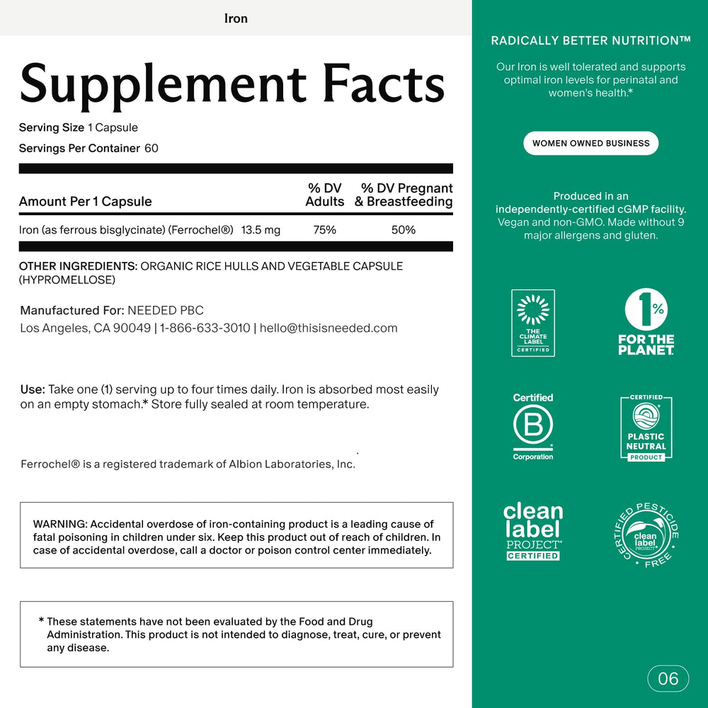 Pregnant woman holding iron supplement