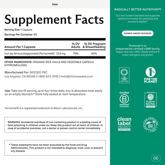 Pregnant woman holding iron supplement