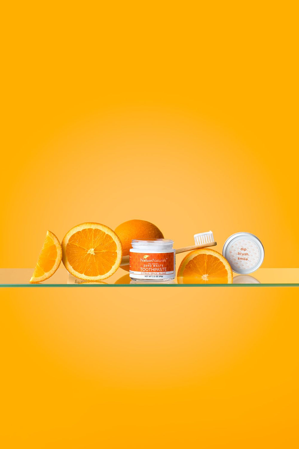 Close-up of Nelson Naturals Citrus Spice Blend toothpaste in a glass jar.