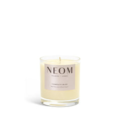Neom Complete Bliss candle blush rose jar closeup highlights luxurious scent for de-stressing rituals.