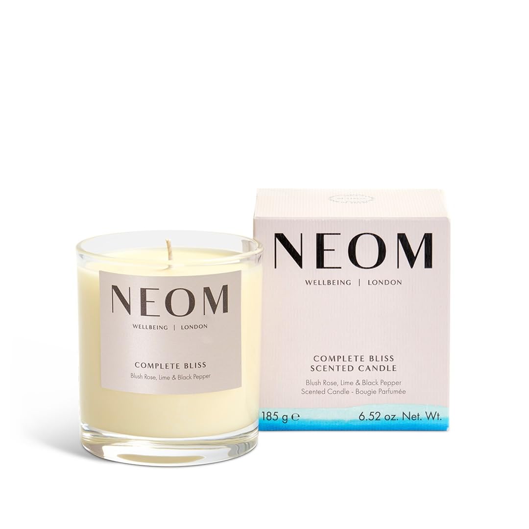 Neom Complete Bliss candle lit wax pool creates a calming ambiance for evening relaxation.