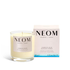 Neom Complete Bliss candle lit wax pool creates a calming ambiance for evening relaxation.