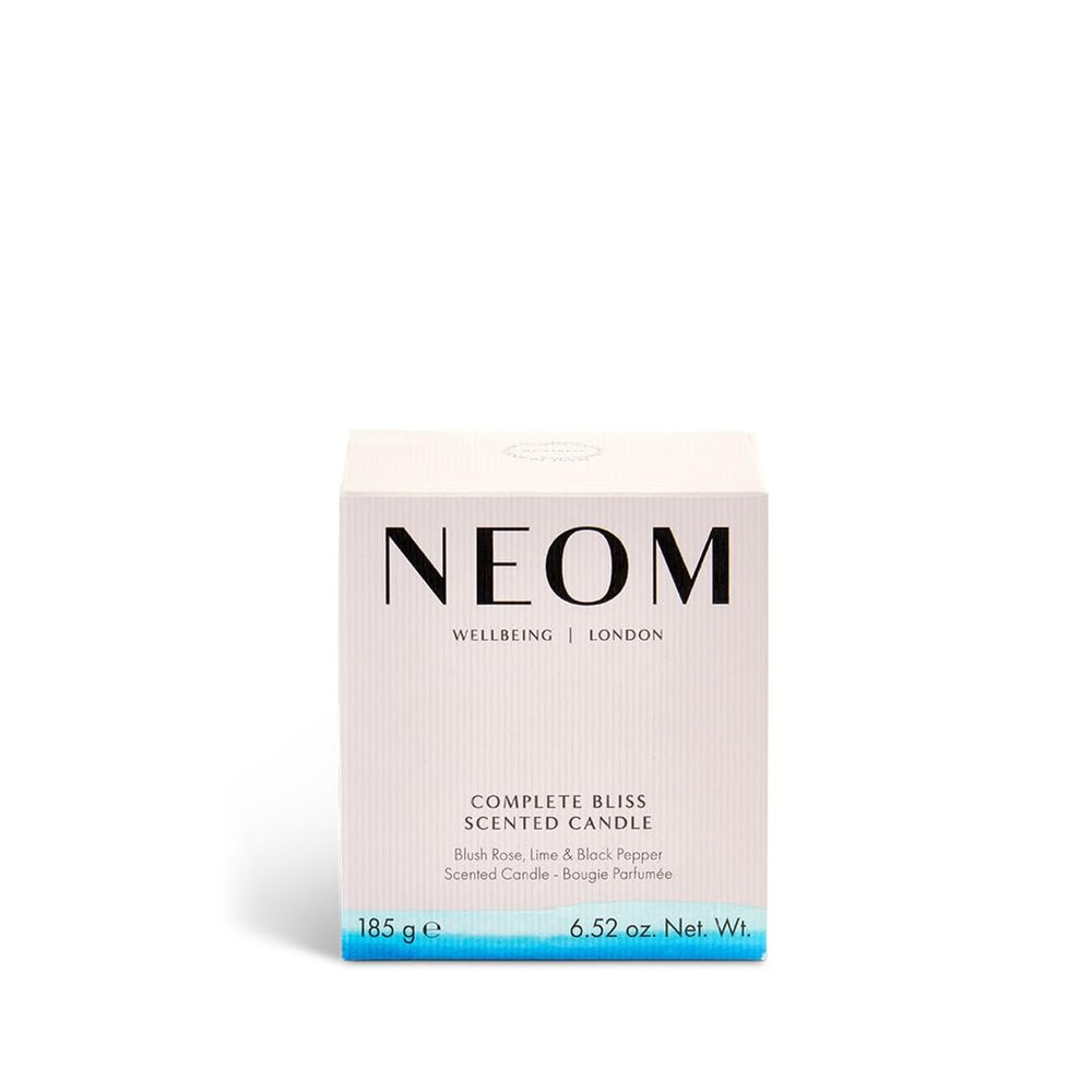 Neom Complete Bliss candle soft amber glow evokes warmth and calm during winding-down routines.
