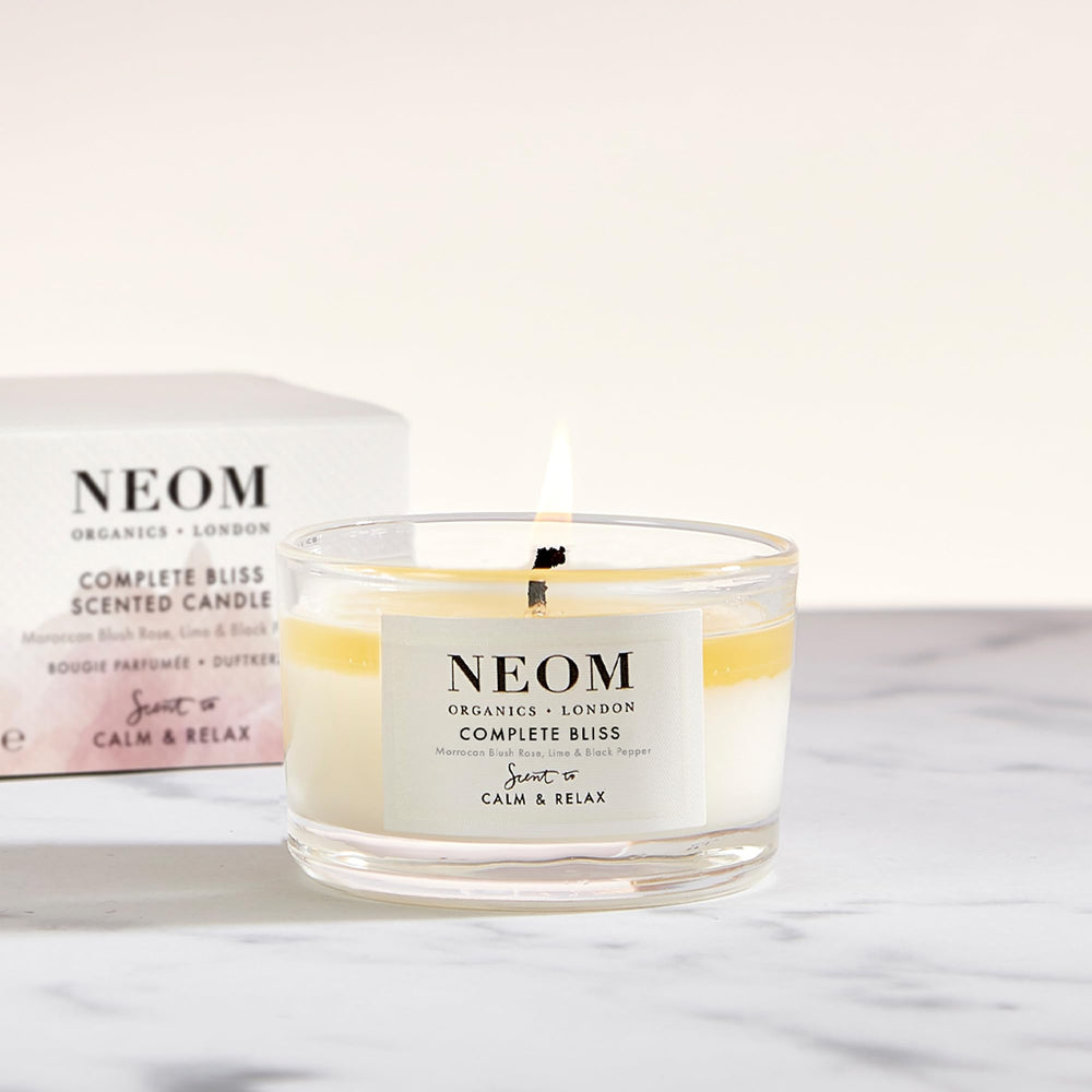 NEOM Complete Bliss travel candle packaging highlights premium wellbeing in a compact design.