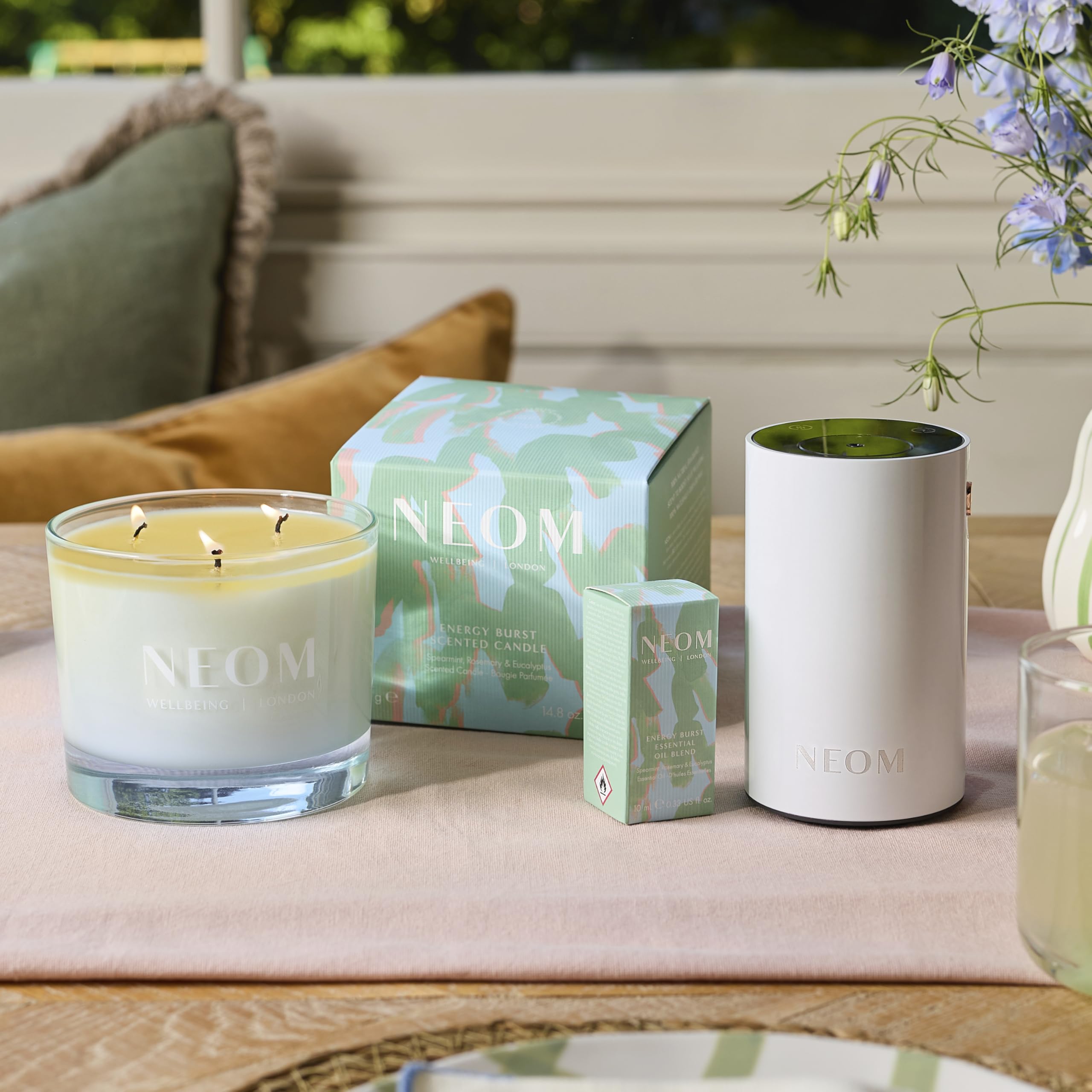 Neom Energy Burst Candle burning with even melt pool for consistent fragrance diffusion.