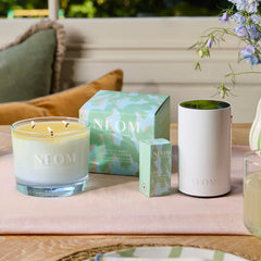 Neom Energy Burst Candle burning with even melt pool for consistent fragrance diffusion.