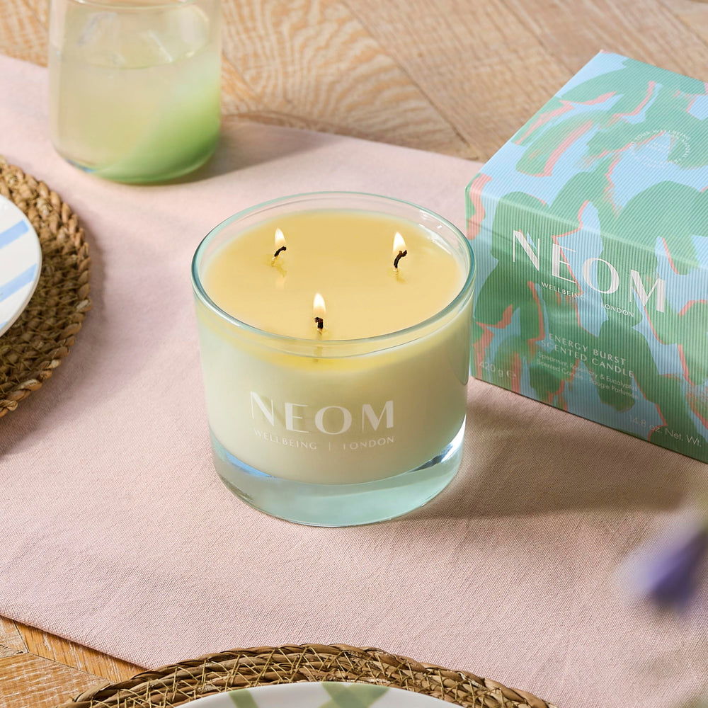 Neom Energy Burst Candle jar and lid on a clean surface for elegant ambience.