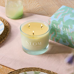 Neom Energy Burst Candle jar and lid on a clean surface for elegant ambience.