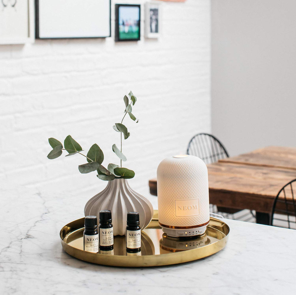 Lifestyle scene with NEOM 10ml bottle for relaxation