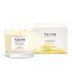 NEOM Feel Refreshed candle closeup with 3-wick setup for even burn and lingering aroma.