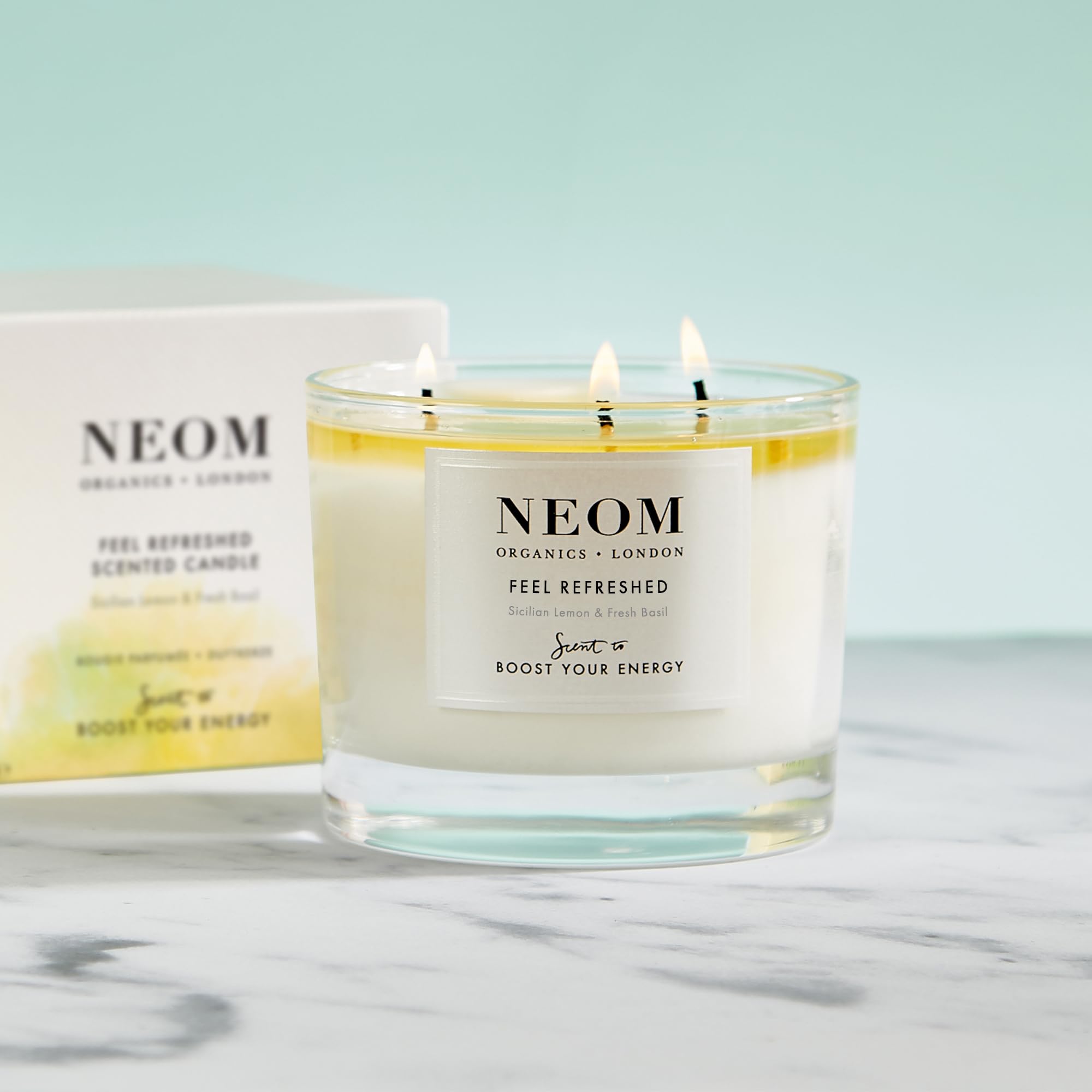 NEOM Feel Refreshed side view highlights elegant trio-wick style delivering steady fragrance.
