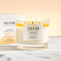 NEOM Happiness candle closeup shows wax pool and inviting aroma for relaxation