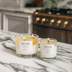 NEOM Happiness candle lit glow enhances cozy ambience