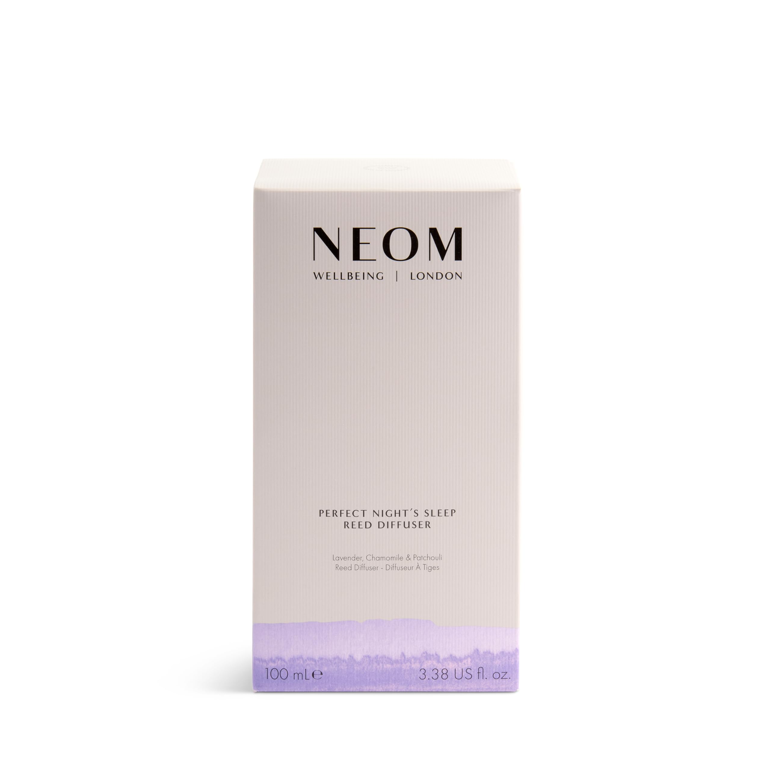 Close-up of amber glass diffuser with reeds