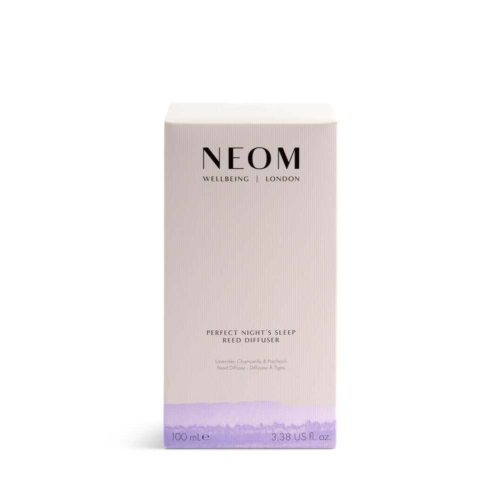 Close-up of amber glass diffuser with reeds