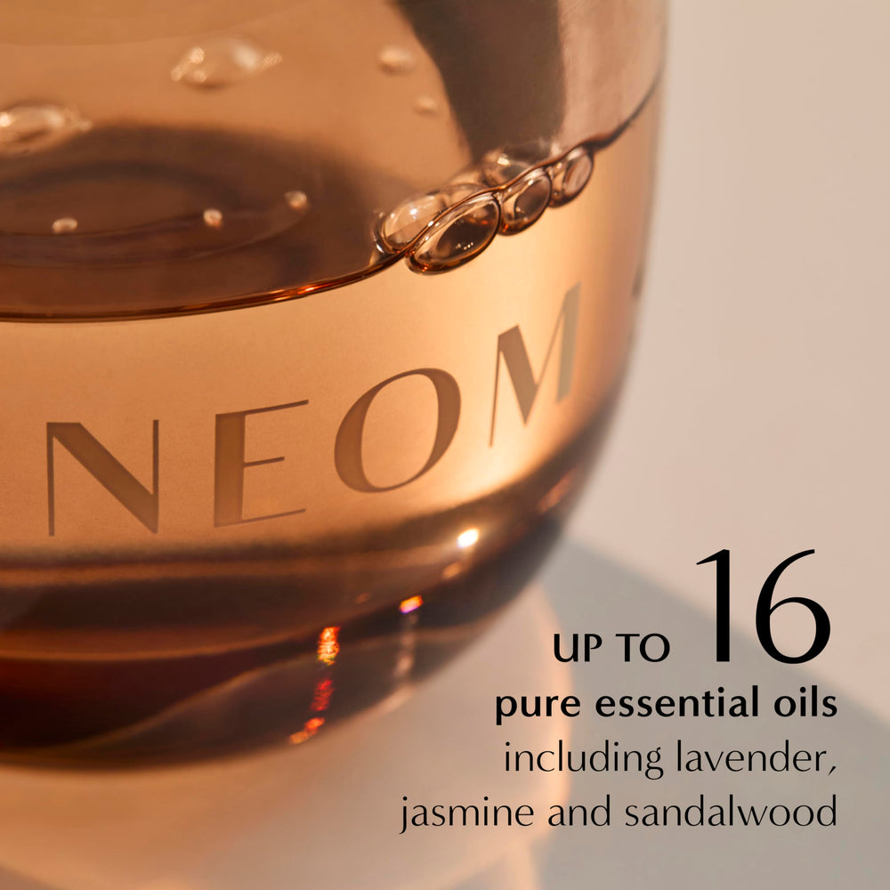Pouring NEOM refill into glass diffuser vessel