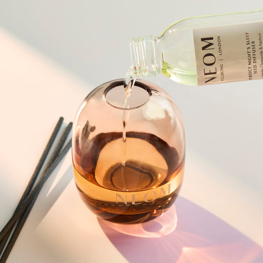 Close-up of NEOM reed diffuser bottle with lavender, chamomile and patchouli