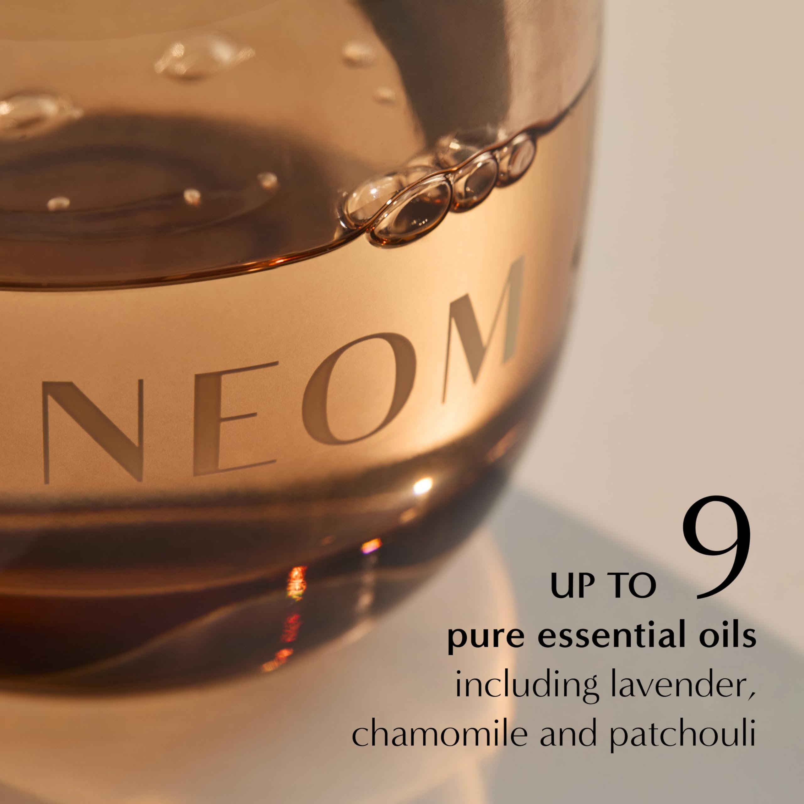 Lifestyle shot of NEOM diffuser refill in a calming bedroom setting