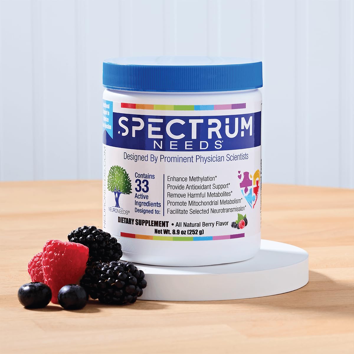 Close-up of SpectrumNeeds scoop beside bottle, illustrating simple daily dosing.