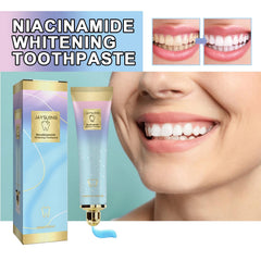 Toothpaste tube squeezed with peach-flavored paste on a toothbrush