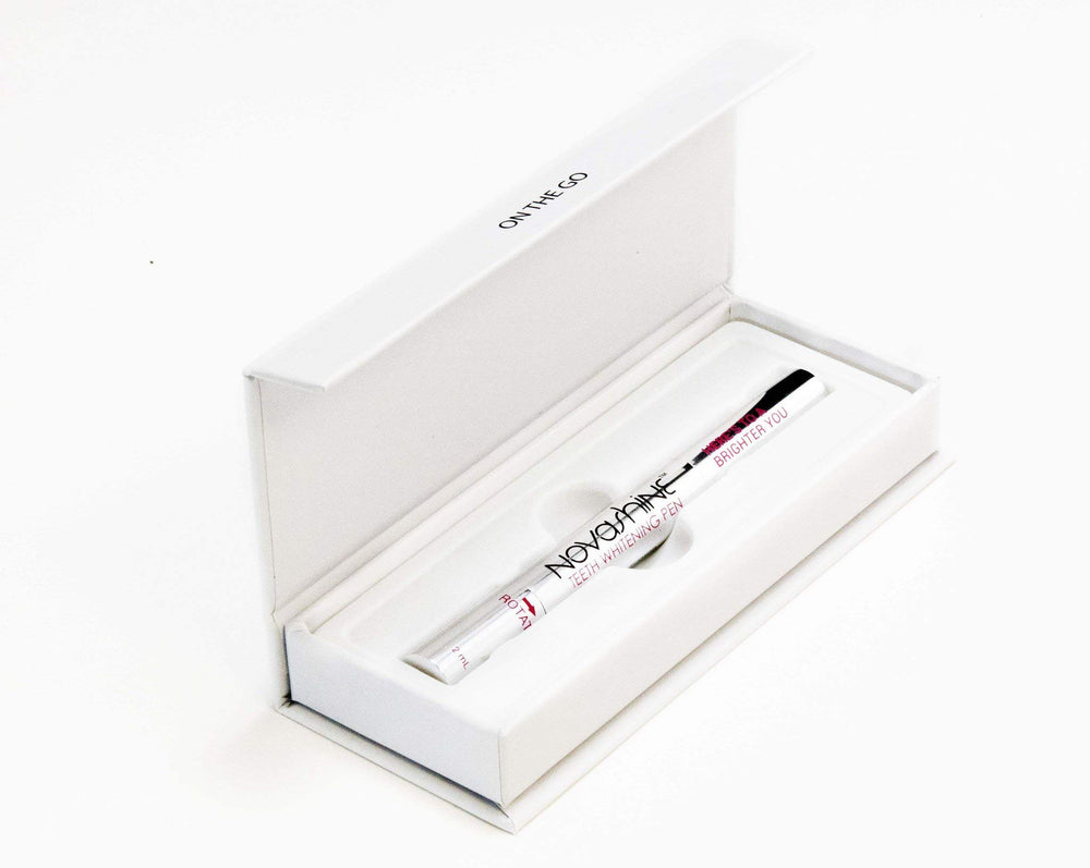 Close-up of whitening pen tip applying gel to tooth