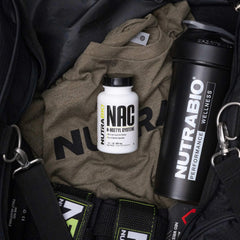 NAC capsules next to bottle on white surface