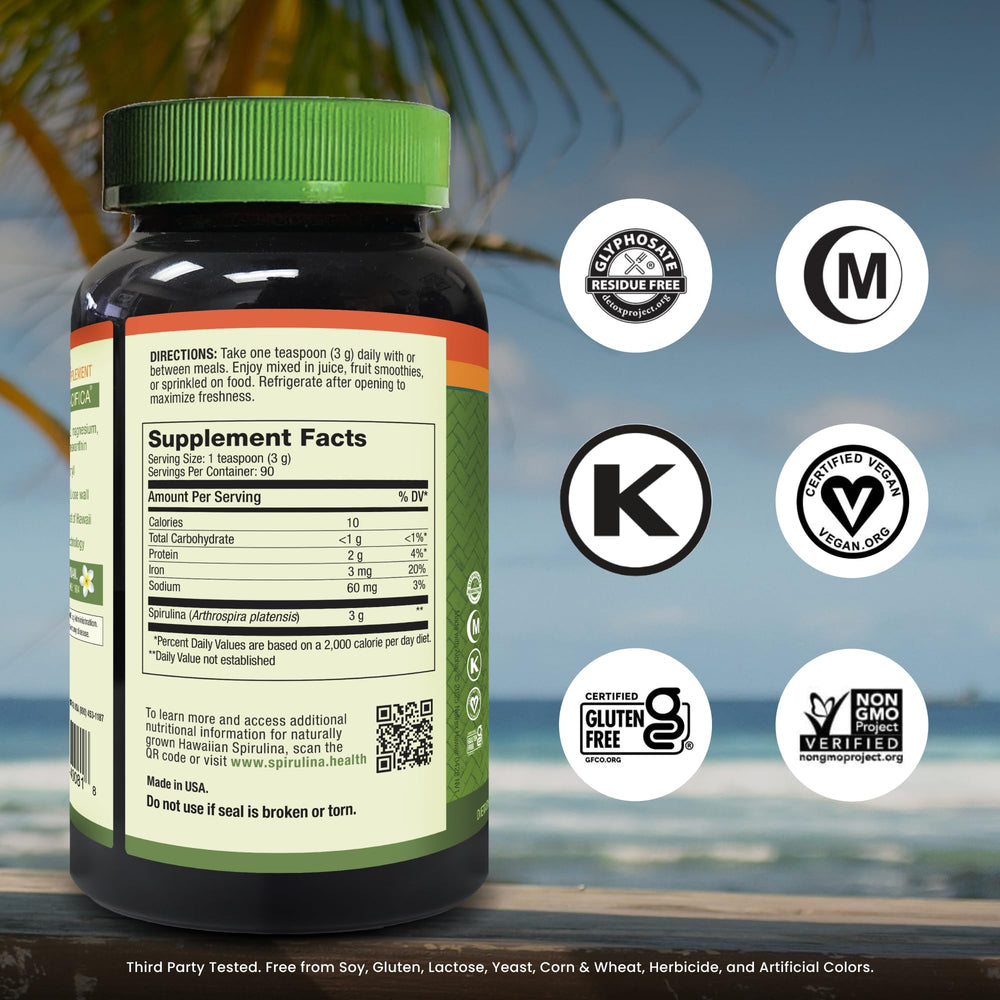 Close-up of spirulina powder container and label showing non-GMO and vegan