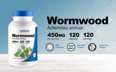 Wormwood capsules spilled on white background