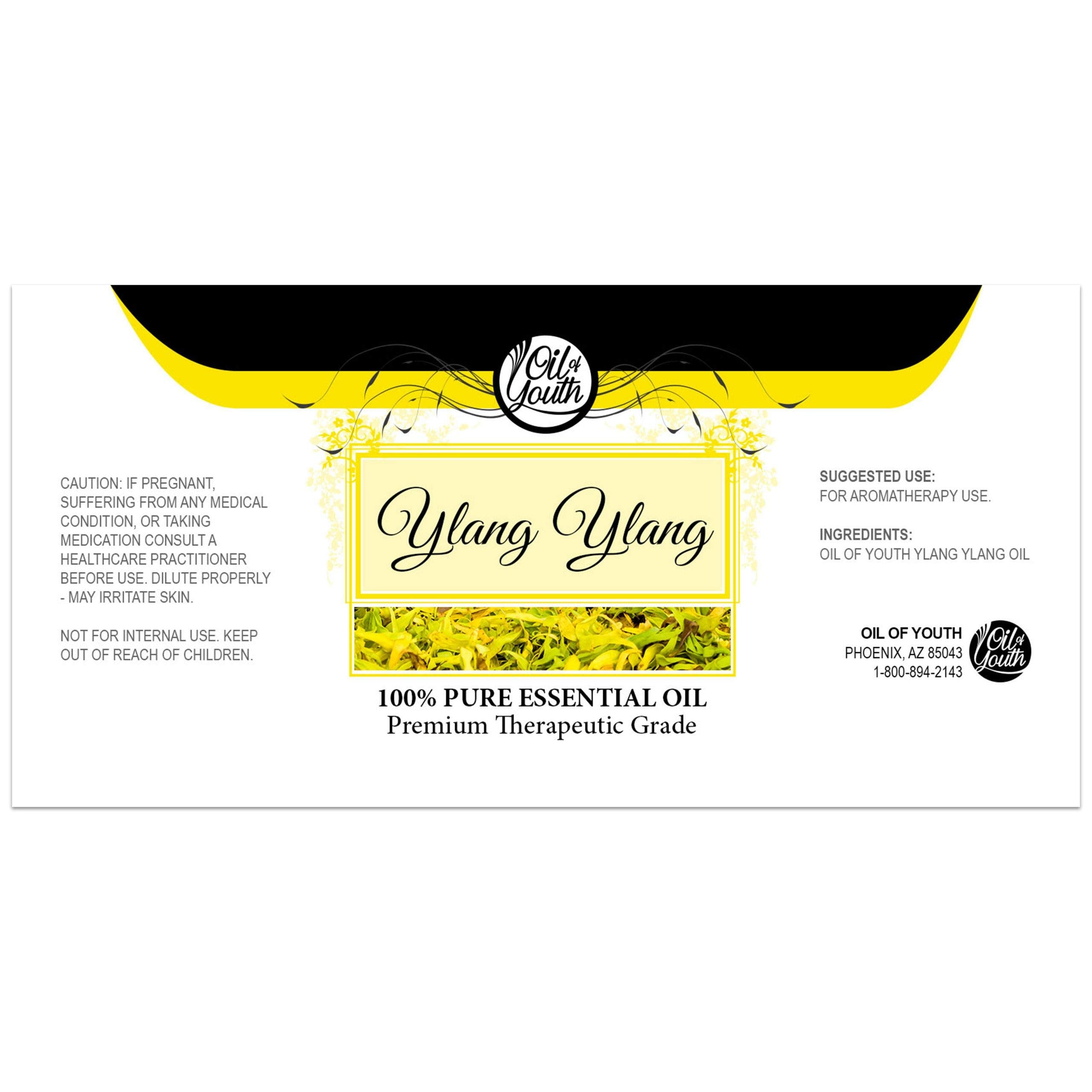 Close-up of yellow Ylang Ylang essential oil in glass bottle