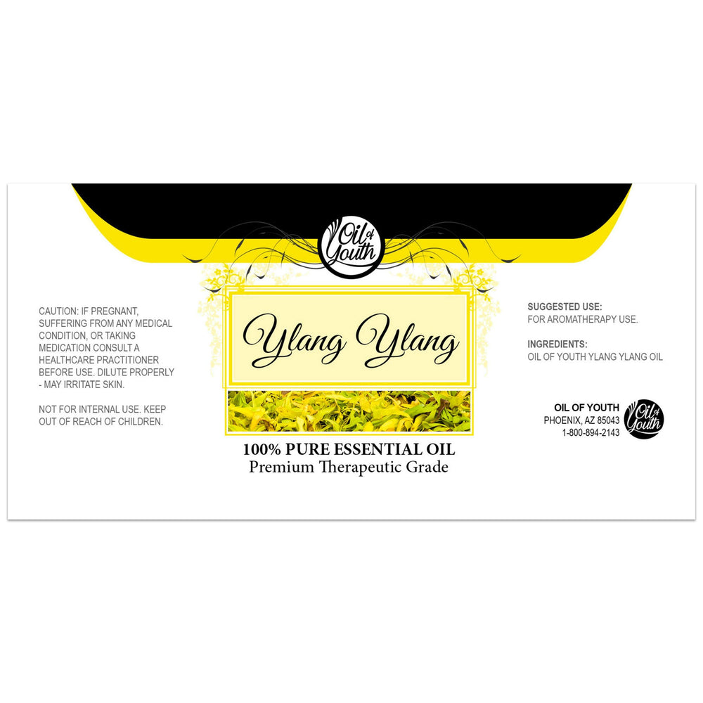 Close-up of yellow Ylang Ylang essential oil in glass bottle